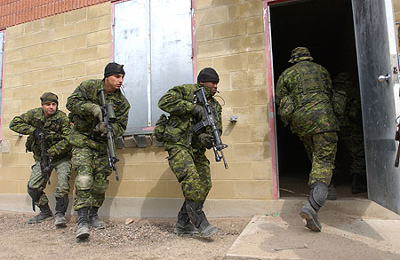 Canadian soldiers entering a building