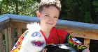 Boy holding garage sale to buy dad a headstone