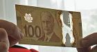 New plastic $100 bills go into circulation