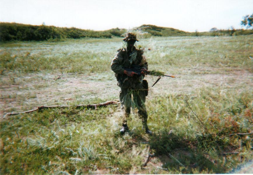 Here's a pic of me during my QL2 course (Basic Training).  We're learning fieldcraft; personal camouflage.  Look at my sloppy half-assed attempt to splay skrim over myself.... lol