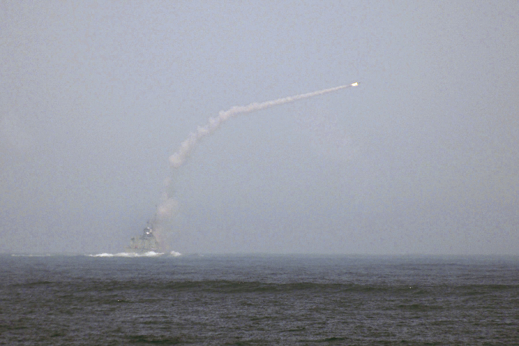 HMCS HALIFAX firing a RIM-7P NATO Sea Sparrow missile at a target drone.