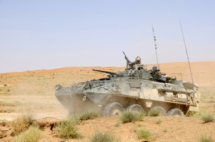 A Royal Canadian Dragoons LAV III grinds through the sand of the Registan Desert near the Canadian forward operating base (FOB).
