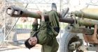 Afghan kids play in graveyard for old Soviet tanks